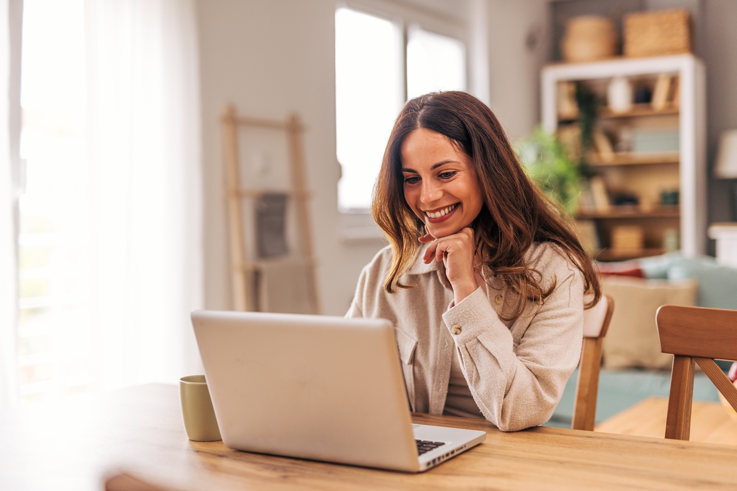 Happy young woman working from home.