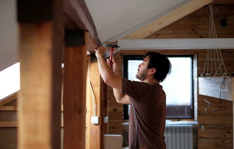 man doing unpermitted work on his house